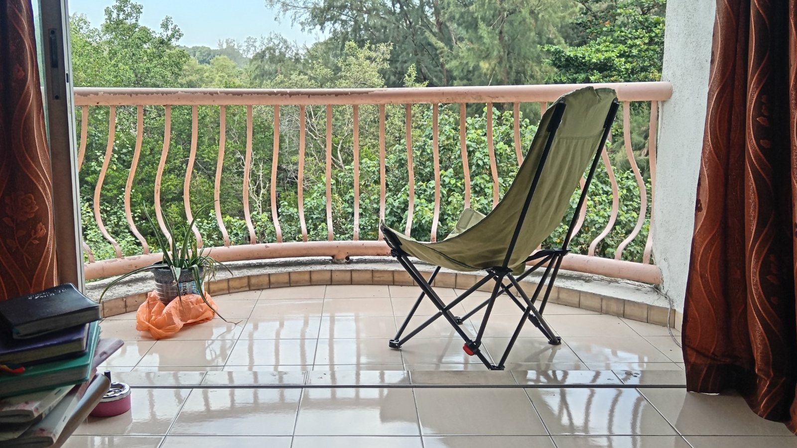 An open balcony looking toward trees, a quiet place for listening and creative work